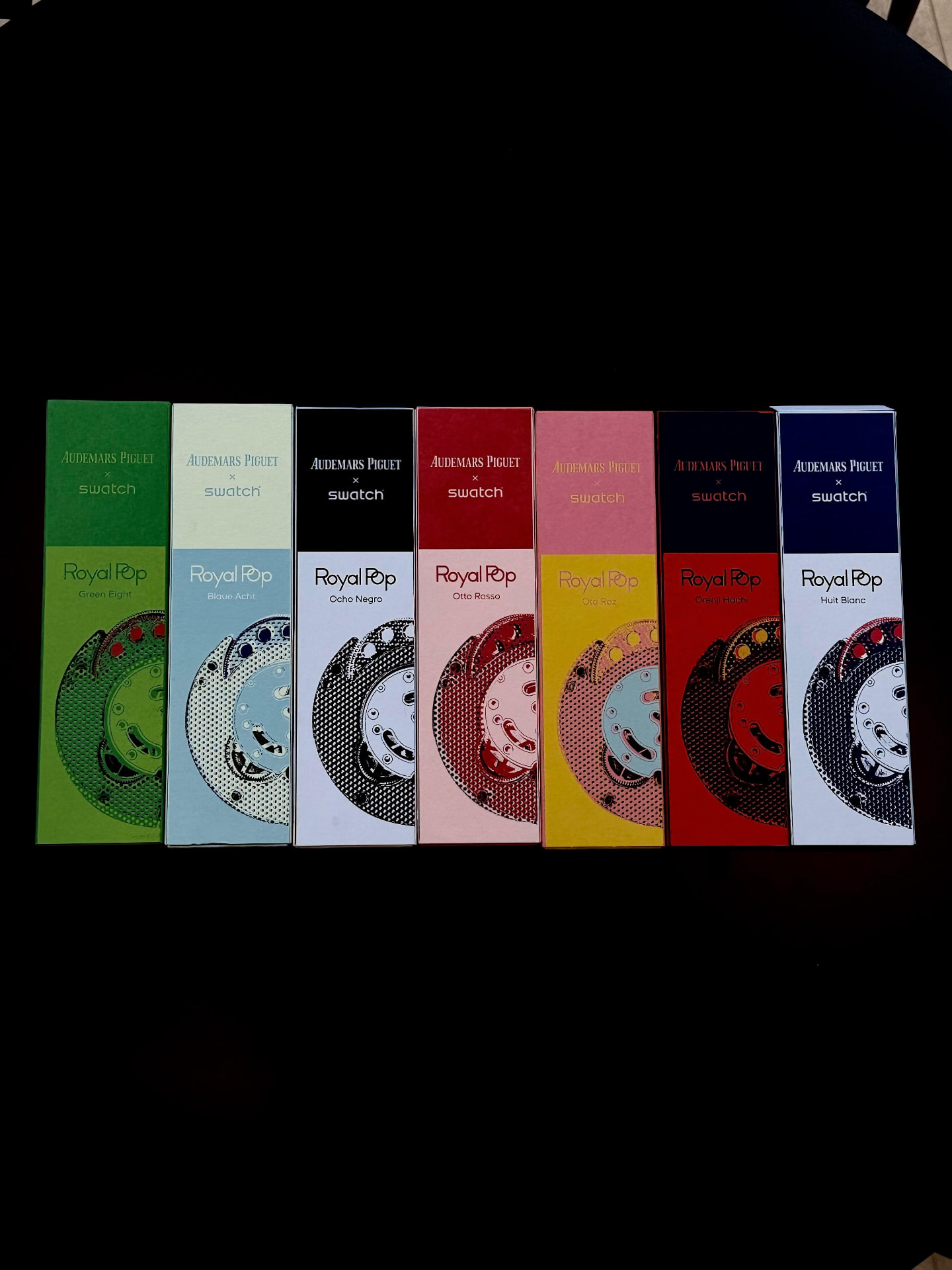 All seven AP × Swatch Royal Pop boxes — Green Eight, Bleue Acht, Ocho Negro, Otto Rosso, Onj Roz, Orenji Hachi and Huit Blanc